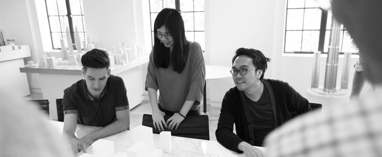 Ye-Ming Lee, Ashley Kim, and Jonathan Cook in a discussion at work.