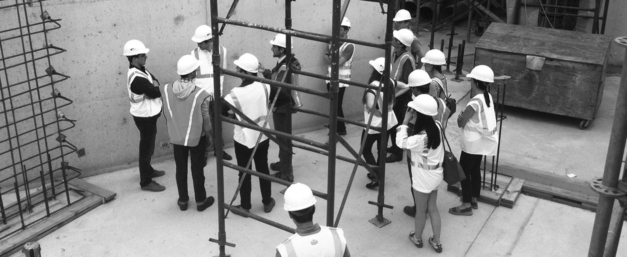 Architects in discussion at a construction site.