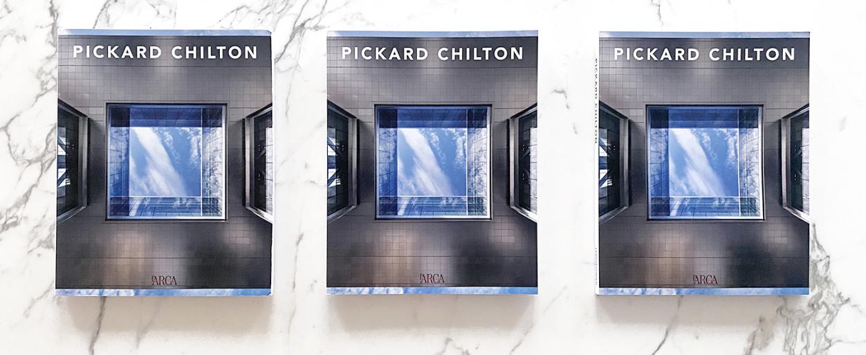 Three copies of L'Arca International's Pickard Chilton monograph