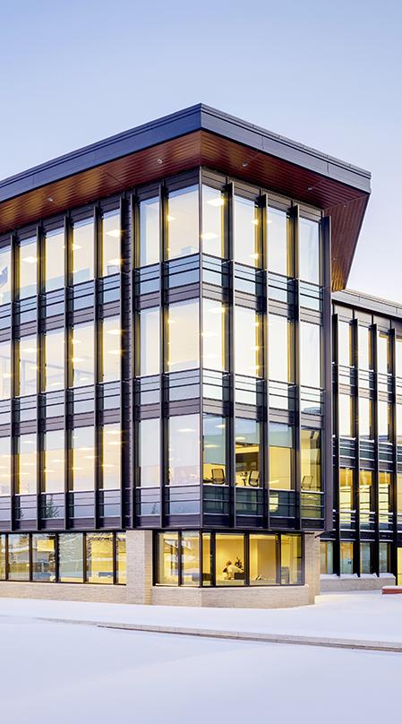 The tall, vertical wood fins and deep roof eaves are tuned to maximize views while optimizing the natural light into the office buildings. The textured fins resemble the tall prairie grasses found throughout the plains.