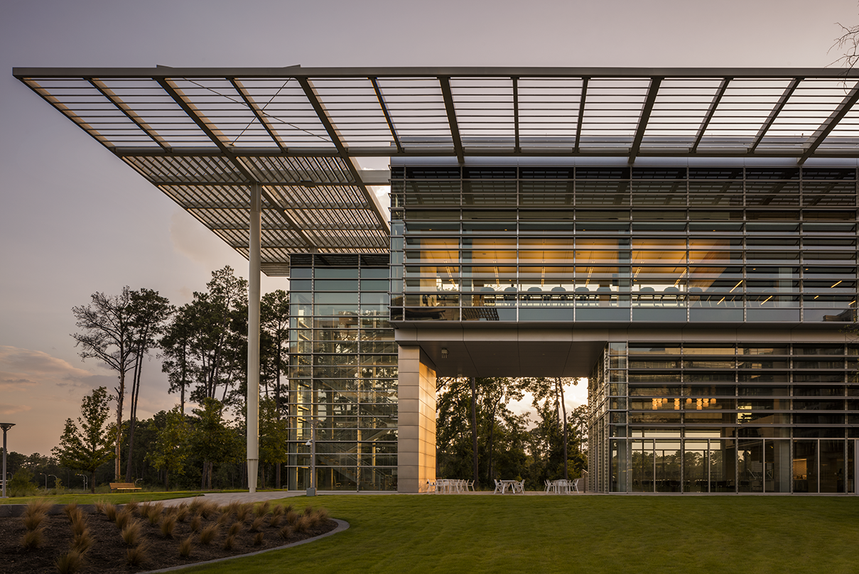 left building side view with roof-top awning at dusk ExxonMobil Wellness Center