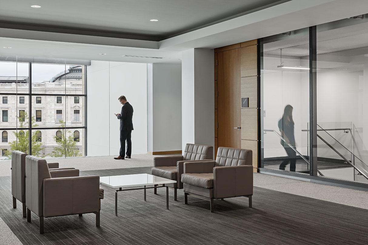 An office inside of the Minnesota Senate Building while a man stands near a window