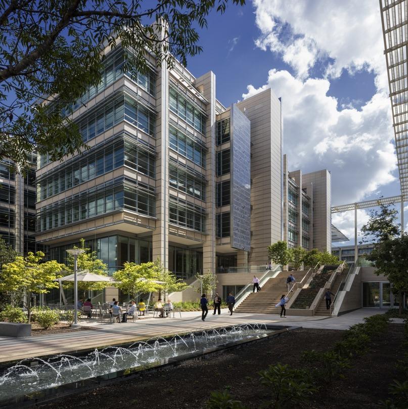 An open area with water fountains along the length of the outside walkway. ExxonMobil Office Complex, Houston, TX