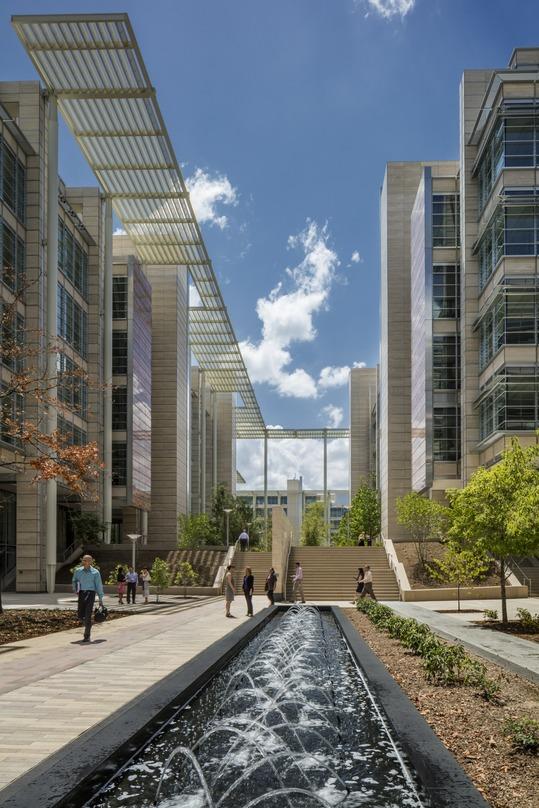 A water fountain along the length of a walkway between building at the ExxonMobil Complex 