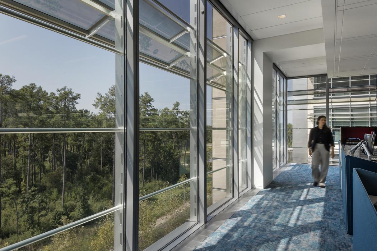 looking out a full height window facade at the ExxonMobil Office Complex