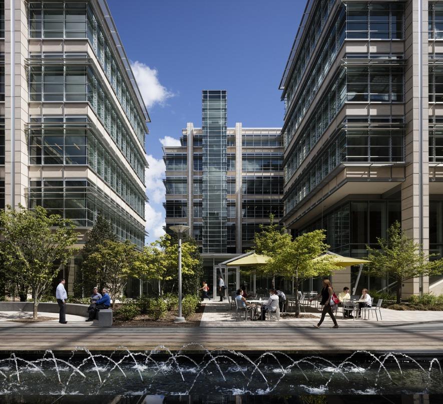 People walking and sitting outside of the ExxonMobil Office Complex