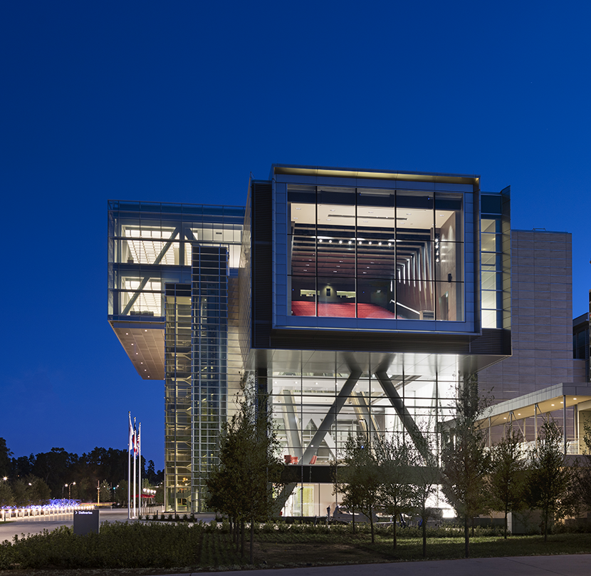 Exterior view of the ExxonMobil Energy Center with glass frame walls and adequate greenery around it. 