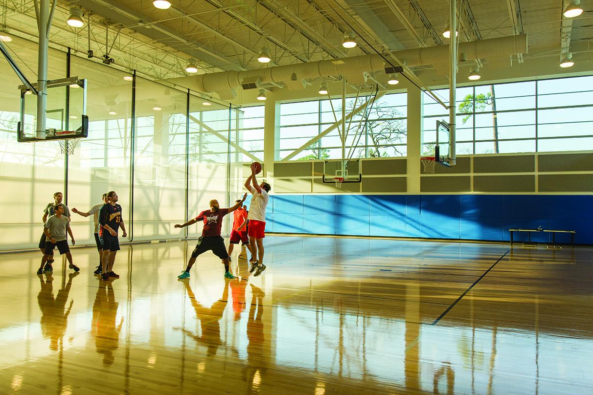 people playing basketball in the gym of the ExxonMobil Wellness Center