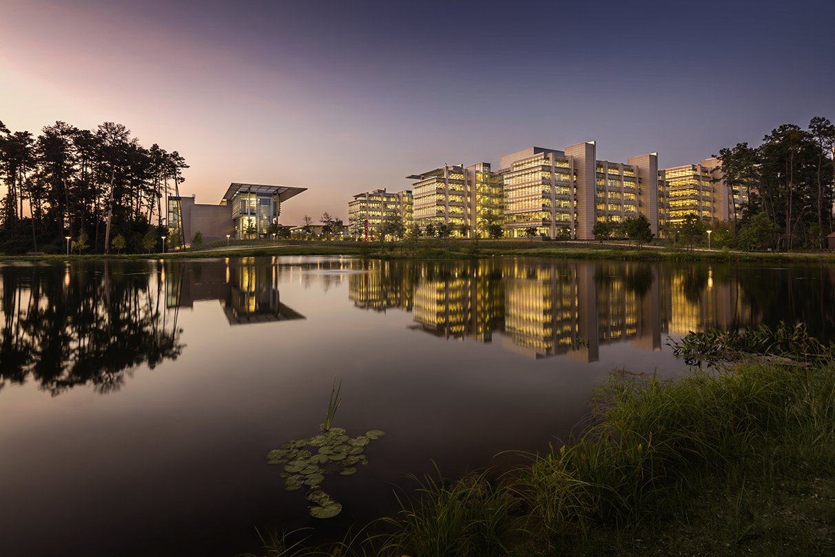 a view from across the pond of the ExxonMobil Wellness Center and full campus 