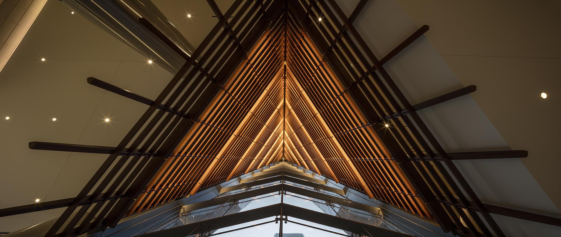 dramatic view looking up at the illuminated wooden screen in the lobby of 609 Main