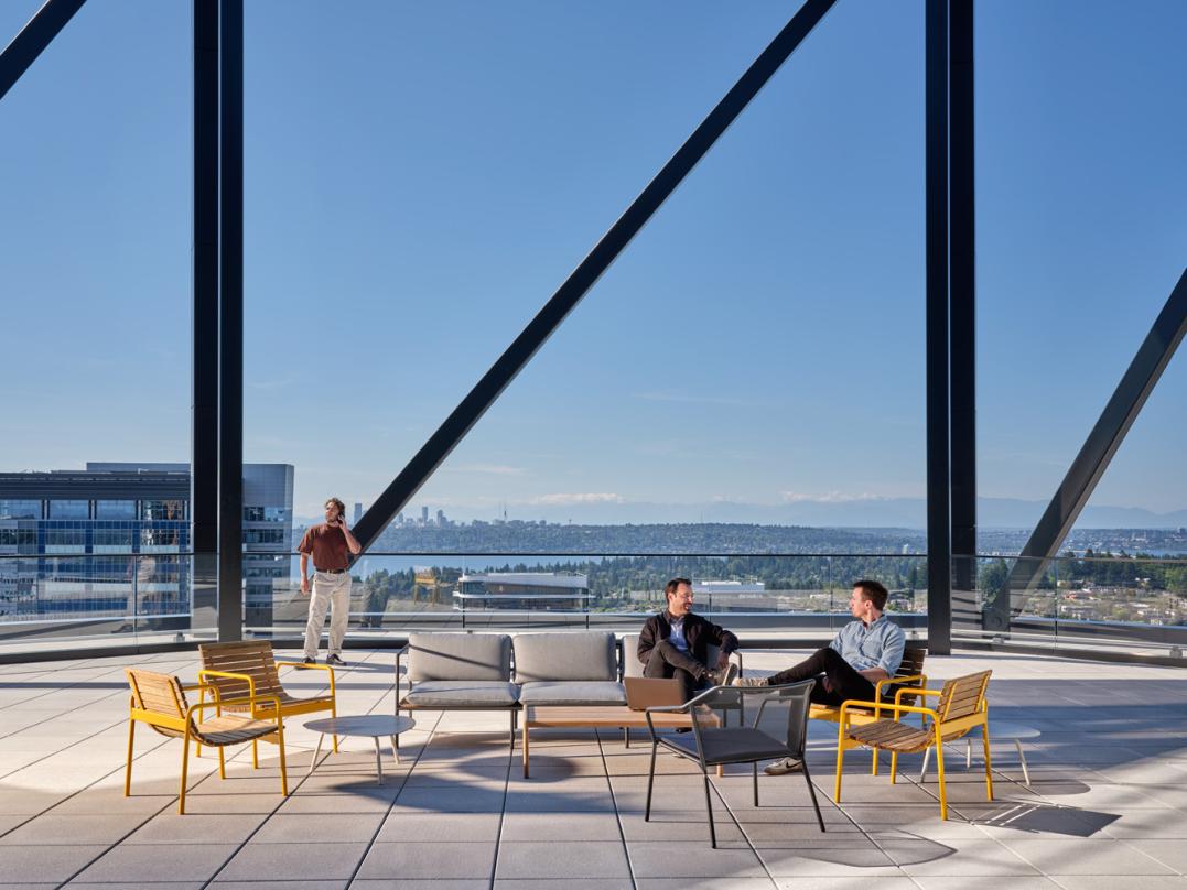 Open air rooftop terrace offers amenity spaces and views of the mountains
