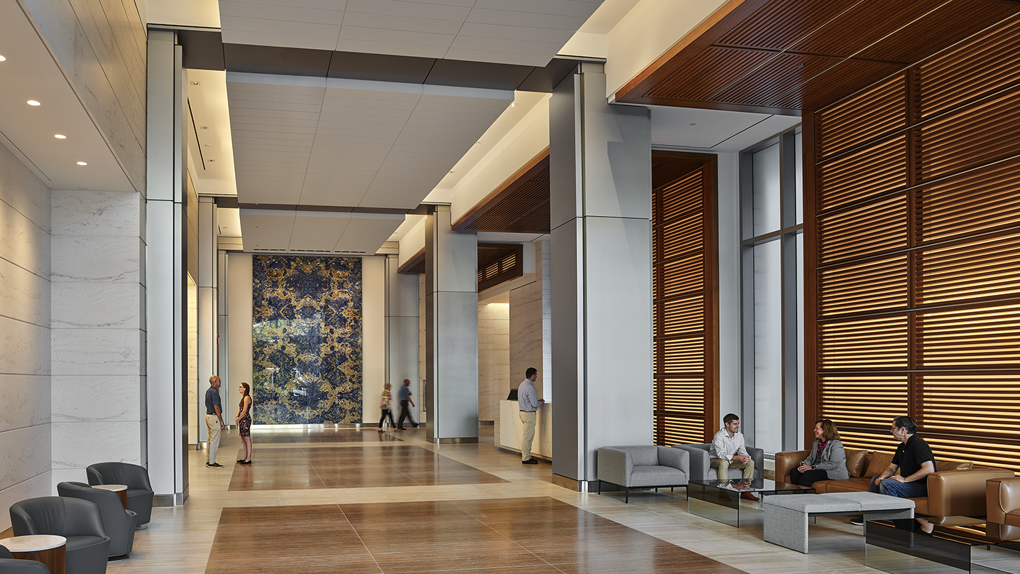 Hospitality lobby with stone wall feature at Avocet Tower and AC Hotel