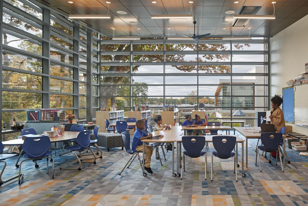 Children in welcoming classroom of Barack H. Obama Magnet University school with glass frame walls in New Haven, Connecticut.