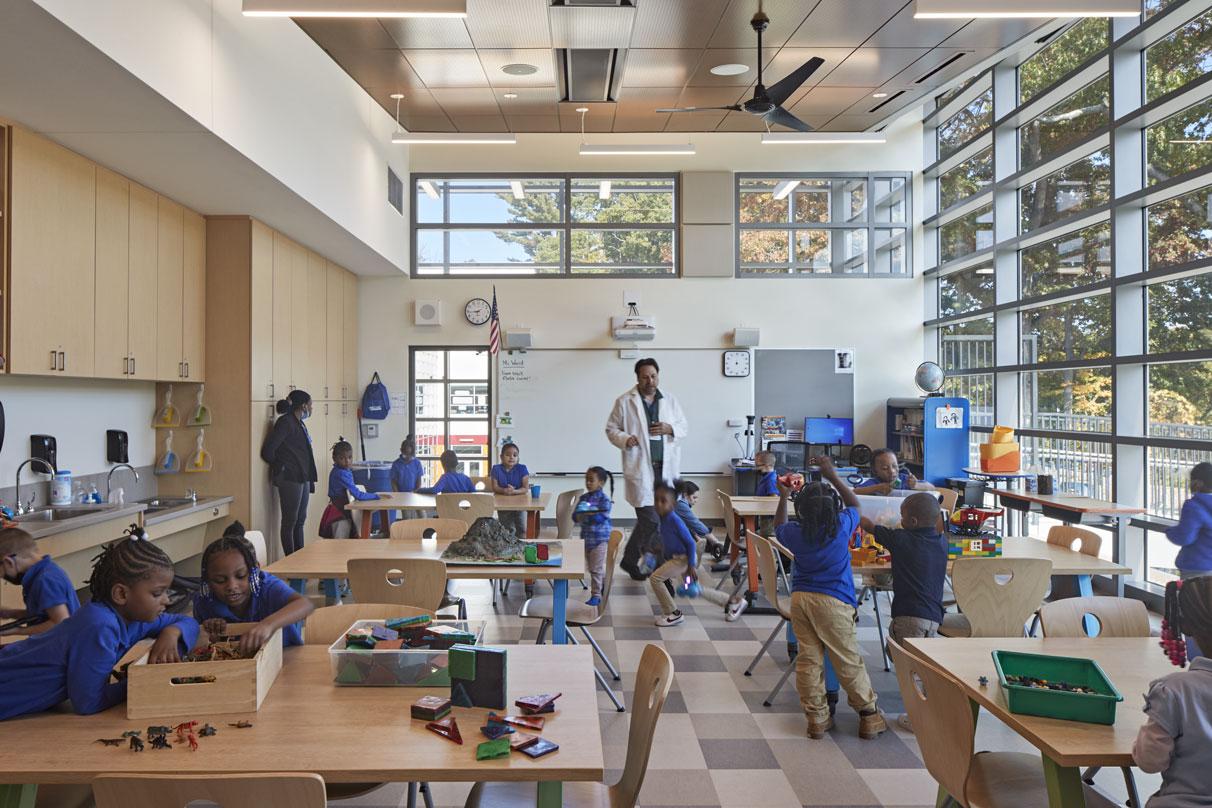 Children exploring in class with open views to outside in Barack H. Obama Magnet University school