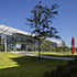 looking at the ExxonMobil Wellness Center with red sculpture on manicured lawn