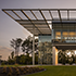 left building side view with roof-top awning at dusk ExxonMobil Wellness Center