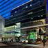 an evening view with a dark blue reflection off the glass facade, with storefronts and the main entrace W Atlanta-Downtown and The Residences