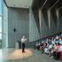 People inside an active lecture room naturally lit from the glass frame walls in ExxonMobil Energy Center, Houston, Texas.