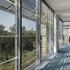 looking out a full height window facade at the ExxonMobil Office Complex