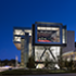 Exterior view of the ExxonMobil Energy Center with glass frame walls and adequate greenery around it. 