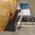 A woman in a red dress walking down a staircase in the Minnesota Senate Building