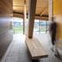 The warm wood structure signifies the heart of the campus and houses the Commons with an arched form that is derived from the hull of a wood strip canoe.