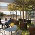 three people sitting and talking outside seating CalPERS Headquarters Complex