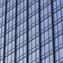 A close up view of the 300 Colorado building which shows the iron railings and glass of the wall