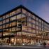 Exterior view of the design proposal for T3 RiNo project with glass frame walls and two exclusive decks on various elevations.
