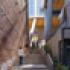 Pedestrian stairway at 2+U in Seattle – urban alley revitalization with exposed brick wall, concrete stairs, and connection to the elevated public plaza.