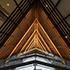 dramatic view looking up at the illuminated wooden screen in the lobby of 609 Main