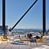 Open air rooftop terrace offers amenity spaces and views of the mountains