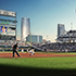 The Mutual of Omaha tower is seen from the baseball diamond while a game plays