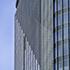 Close-up of the Takanawa Gateway City skyscraper's glass and metal facade, showcasing its modern architectural design.
