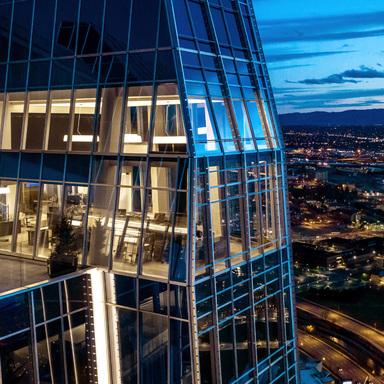 The lighted exterior view of a top storey in 1144 Fifteenth, a high performance office tower located in Denver, Colorado. 