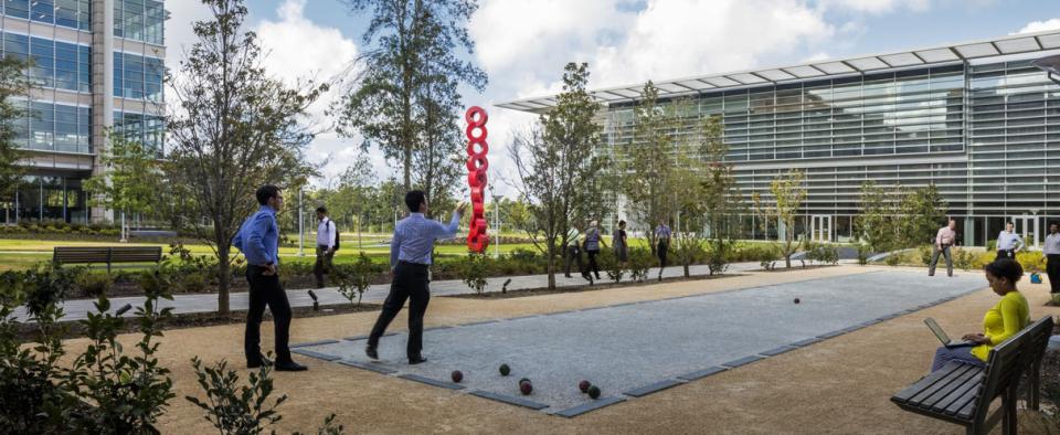 Outdoor recreational space at a corporate headquarters, with employees playing games, designed by Pickard Chilton to promote engagement and well-being