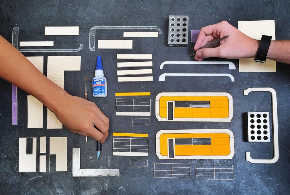 Things used by the Pickard Chilton team to create miniatures for a design proposal laid out on a table.