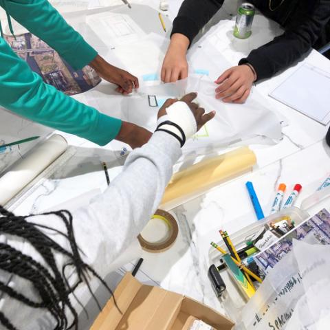 Pickard Chilton employees discussing a project over their work table.