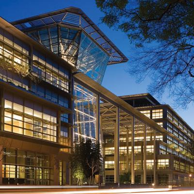The exterior view of a lighted CalPERS Headquarters Complex that incorporates sunshades, light shelves, and greenery.