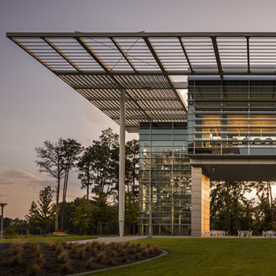 The glass lighted exterior design of the ExxonMobil Energy Center located in Houston, Texas projecting its reflection.