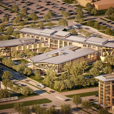 Aerial view of Texas A&M’s Aplin Center, a modern three-story, 211,724 sq ft mass-timber building surrounded by trees and green space.