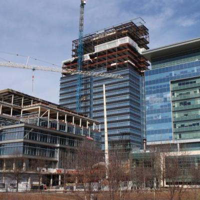 CoStar Group's 26-story riverfront office tower under construction in Richmond, featuring cranes, steel framework, and a partially completed glass façade.